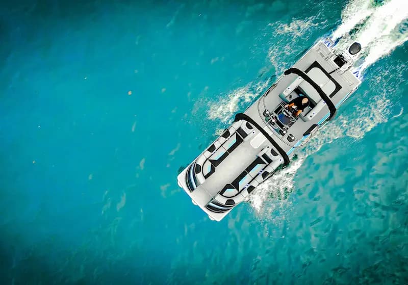 Vision Marine V30 viewed from above, cruising across clear turquoise water with white wake.