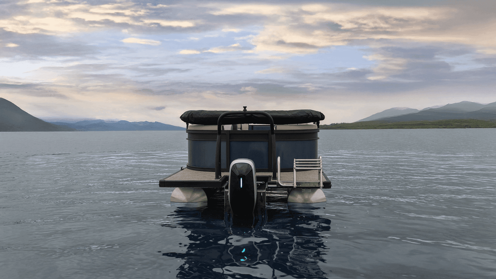 Flagship Discover seen from the stern, with its outboard motor centered between the pontoons on a mountain lake.