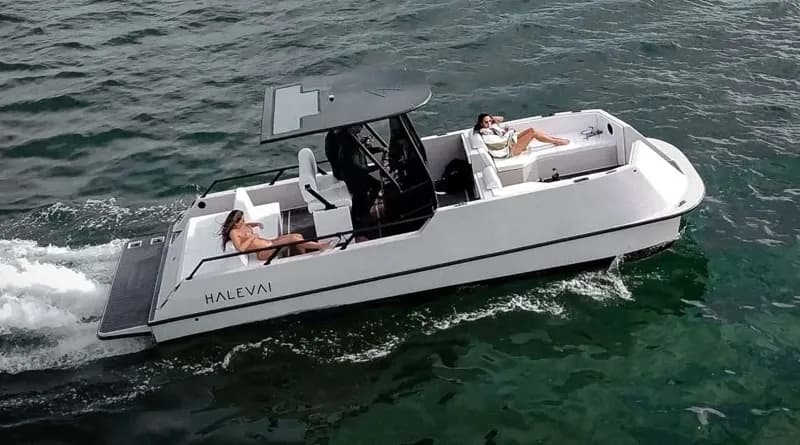 Halevai model2050 electric boat cruising on open water, with two passengers seated aboard and a covered center console.