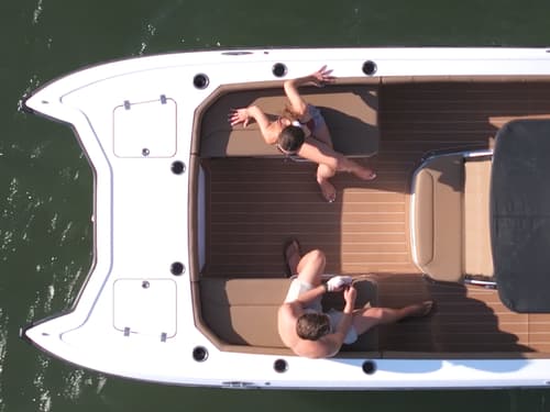 Volare Artemis 23 cockpit viewed from above, with two people seated in the open boat.