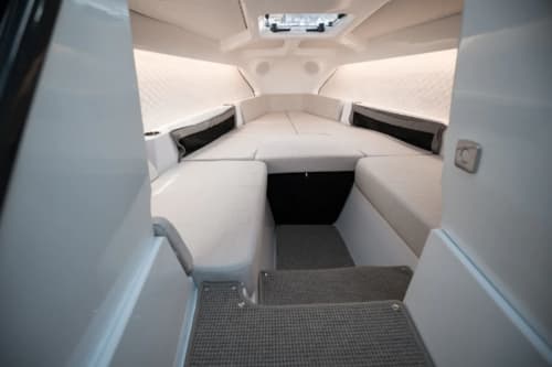Candela C-8 cabin interior viewed from the entry, showing forward seating, side windows, and steps.