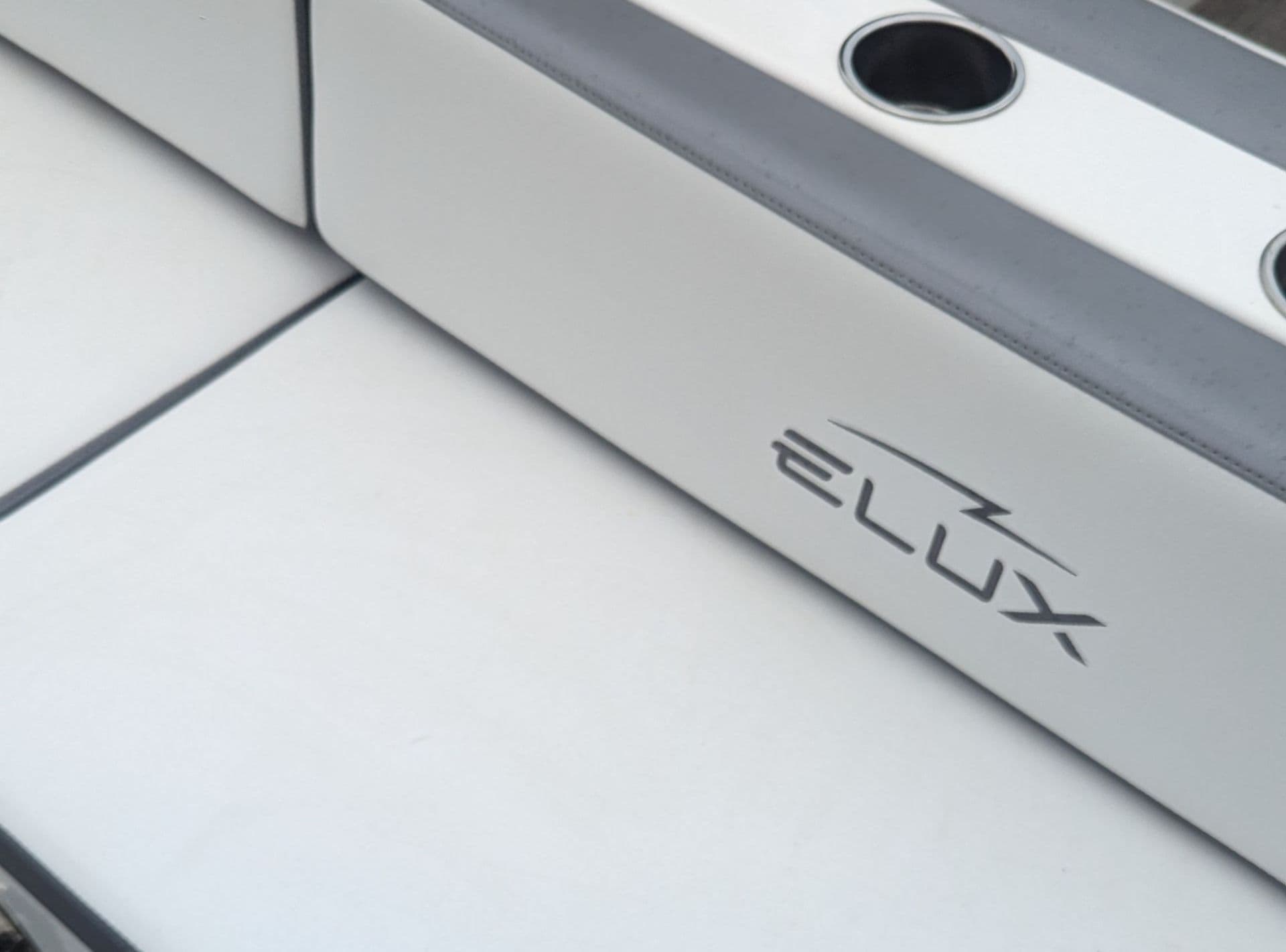Flux Marine GFX Stealth side detail showing the ELUX logo on a light-colored interior panel and nearby cup holders.
