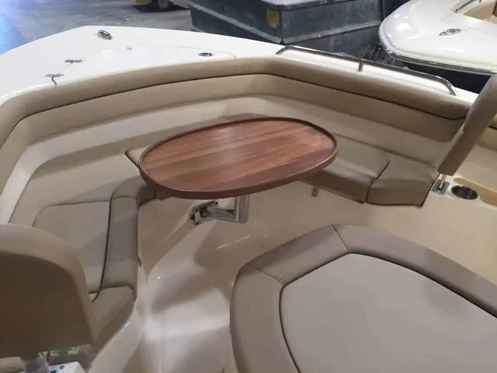 Removable wood-look table in the bow seating area of a Scout 215 XSF boat.