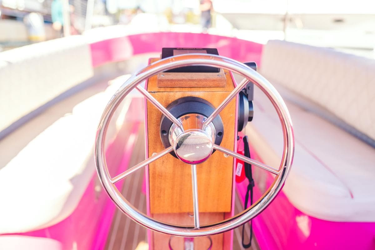 2024 Vision Marine Fantail 217
Close-up of the polished steering wheel and wood-paneled helm aboard a 2024 Vision Marine Fantail boat.