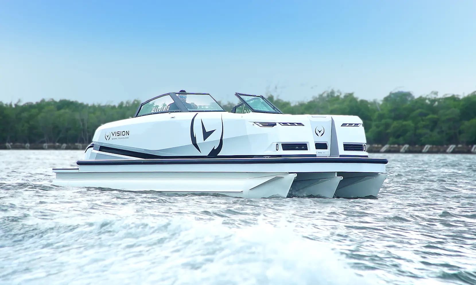 White Vision Marine SPECTR electric trihull  with black accents, cruising on a lake, viewed from the side with trees along the distant shoreline.