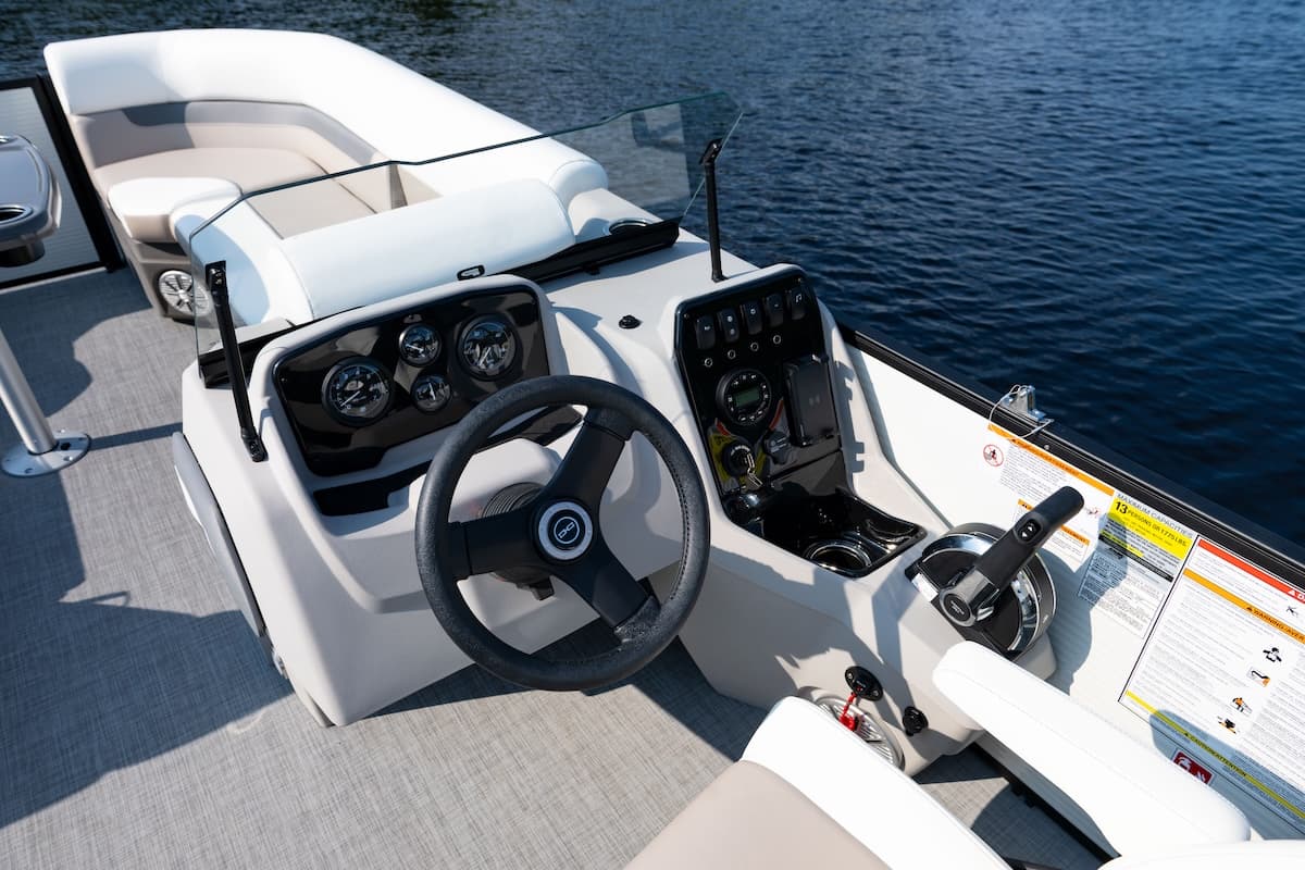 Helm and cockpit console of a Princecraft Vectra 21 RL, viewed from above, with steering wheel, gauges, controls, and rear seating.