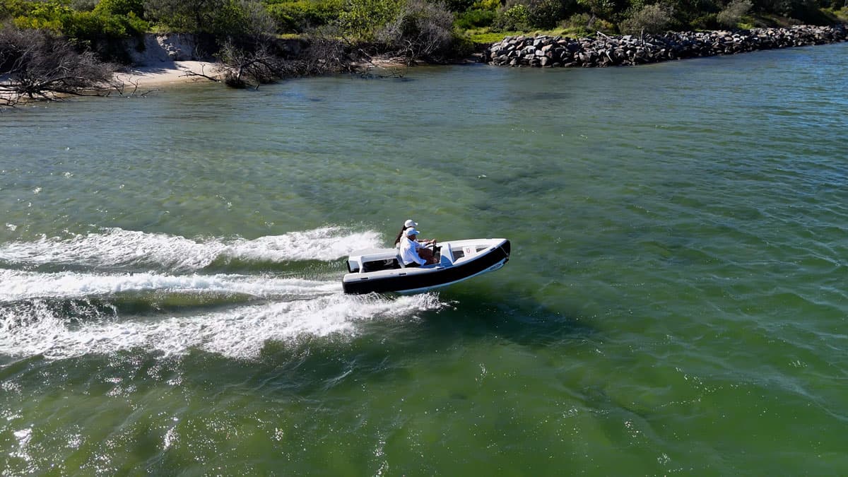 Offshore Cruising Tenders OC330 underway on coastal water, viewed from above with wake trailing behind.