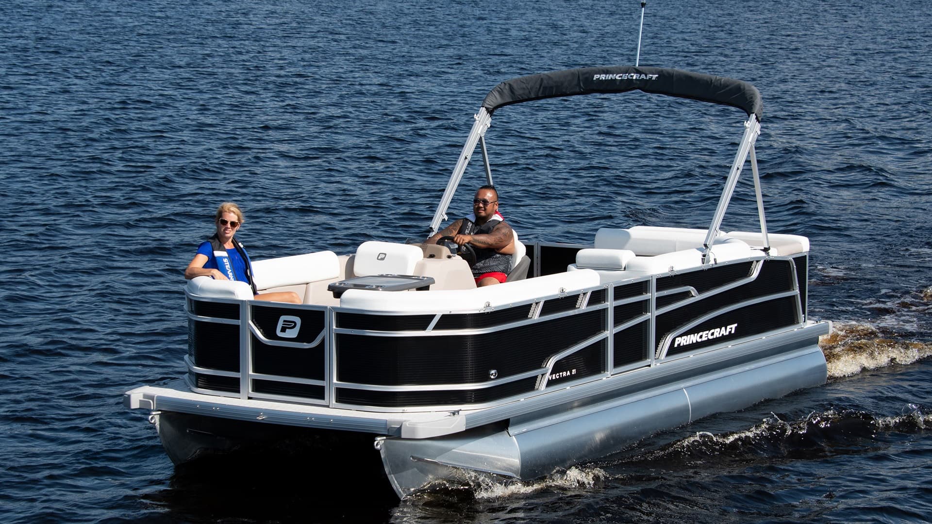 Princecraft Vectra 21 RL pontoon boat cruising on open water, viewed from the front-left side.
