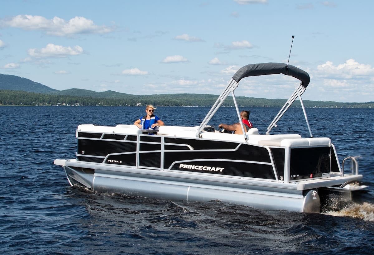 Princecraft Vectra 21 RL pontoon boat underway on a lake, viewed from the starboard side.