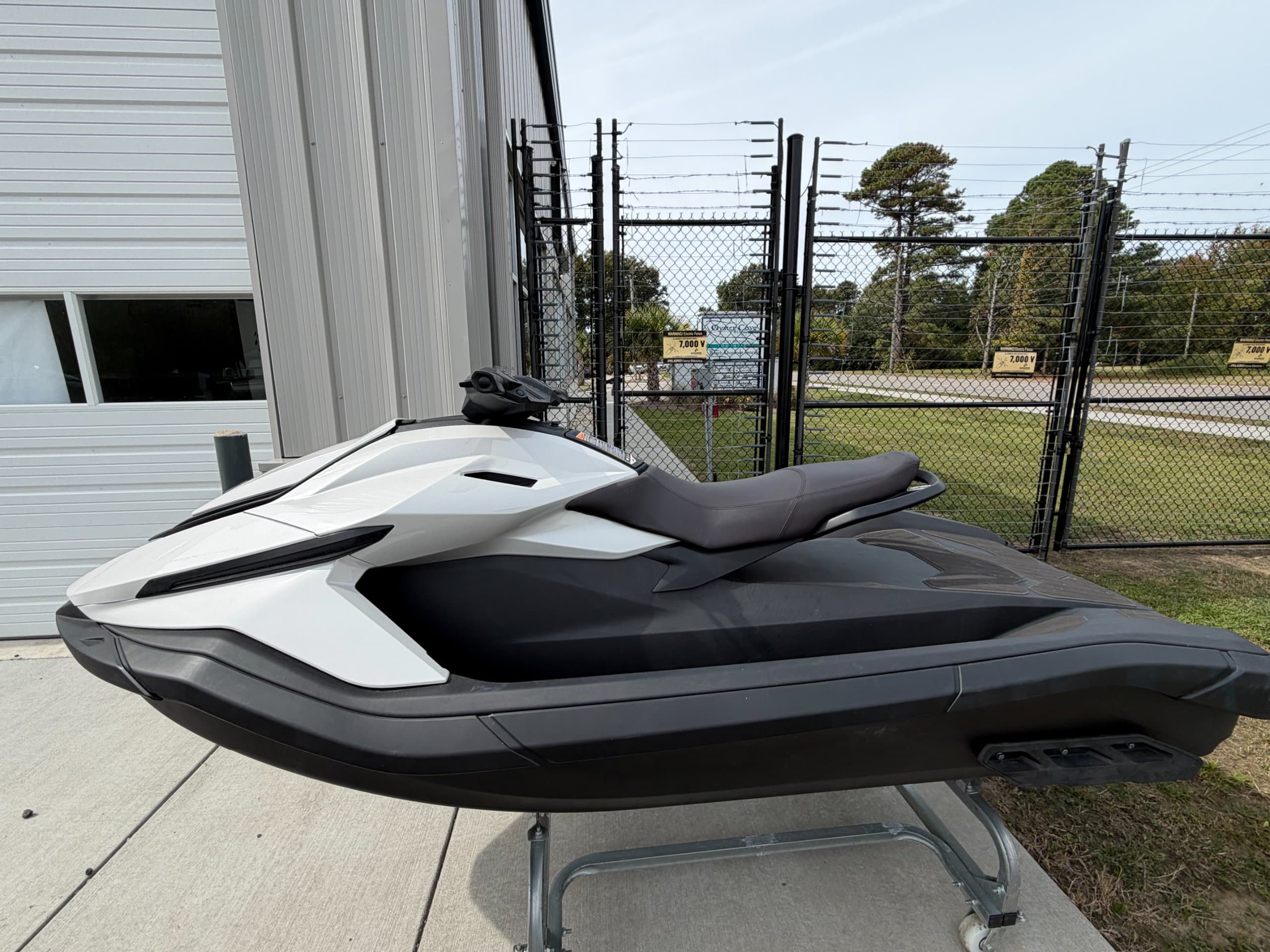 Side view of a white-and-black Taiga Orca P2 personal watercraft on a display stand.