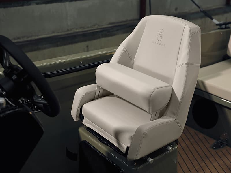 White helm seat and steering wheel in the cockpit of the 2024 X Shore 1, viewed from the side.