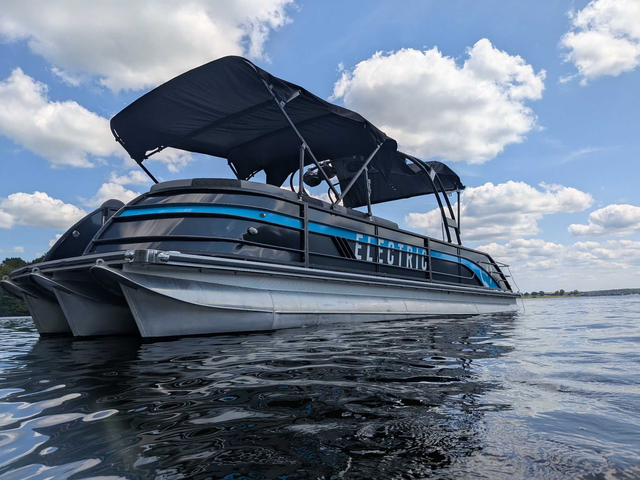 Vision Marine V30 pontoon boat viewed from the front side at water level.