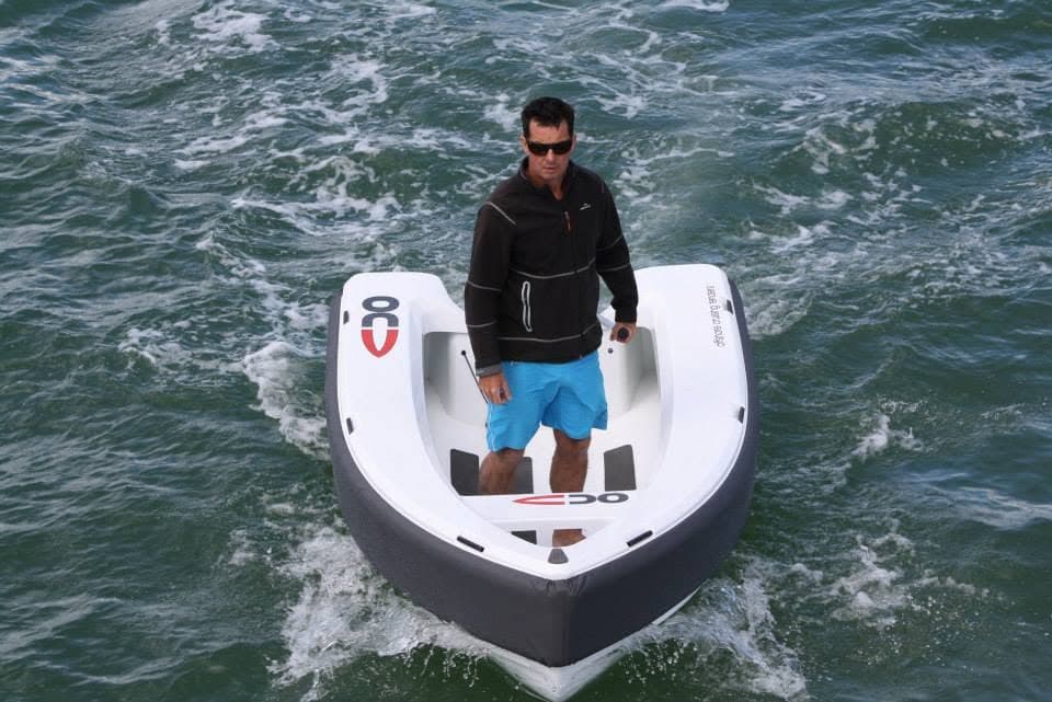 Offshore Cruising Tenders OC330 viewed from above at the bow, with a person standing in the tender on choppy water.