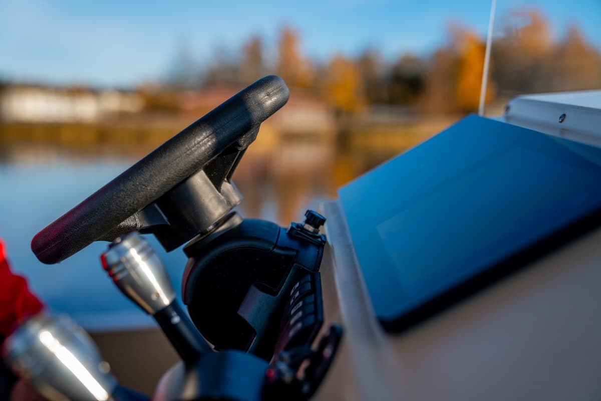 Elvene Amber helm and steering controls, close-up from the side with the bow deck visible.