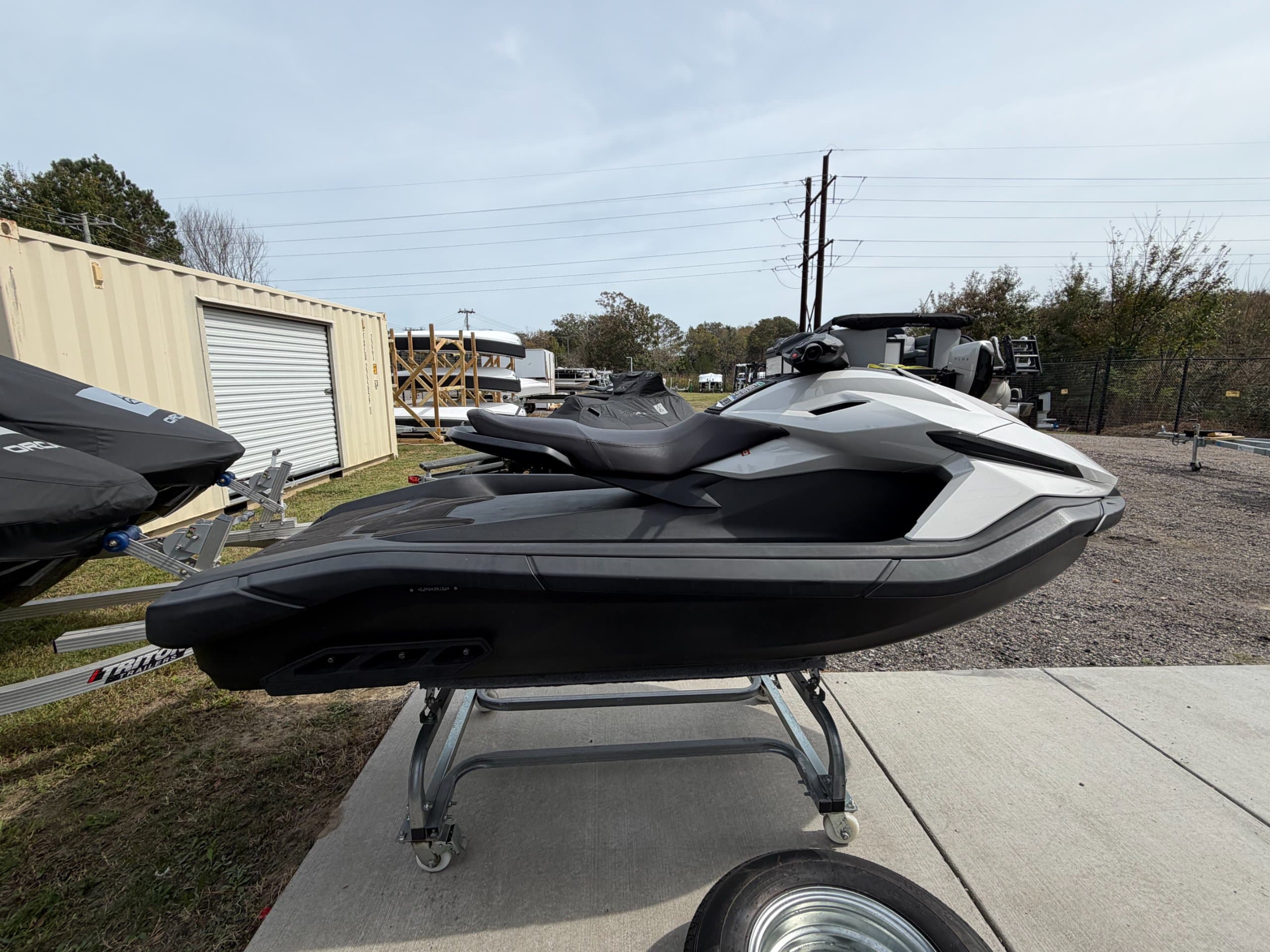 Side view of a black and white personal watercraft on a display trailer.