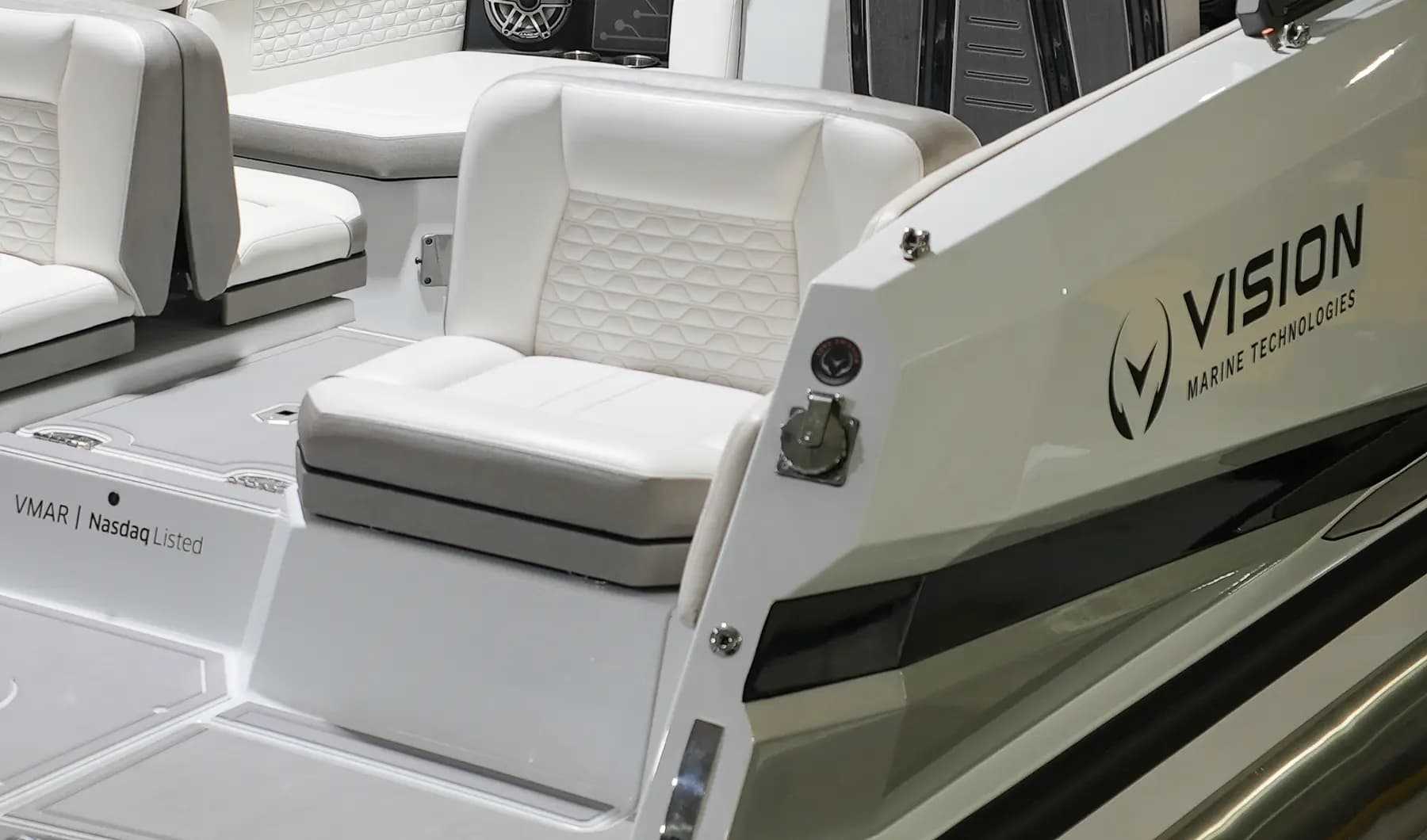 Close view of the Vision Marine SPECTR cockpit, showing a helm-side seat, rear seating, and Vision Marine Technologies branding.