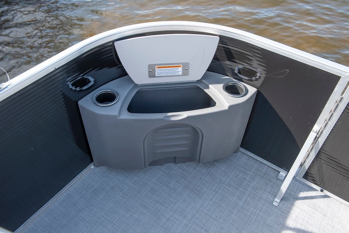 View from the bow into the front seating area of a 2026 Princecraft Jazz 17, showing a molded console, cup holders, and carpeted deck.