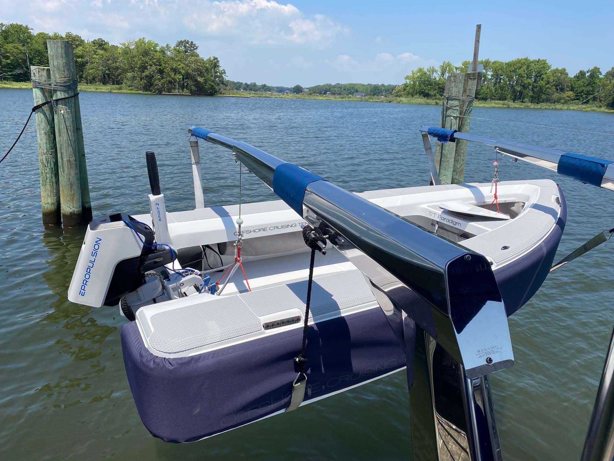 2026 Offshore Cruising Tenders OC350 viewed from the stern quarter, showing the cockpit, outboard motor, seating, and dockside mooring.