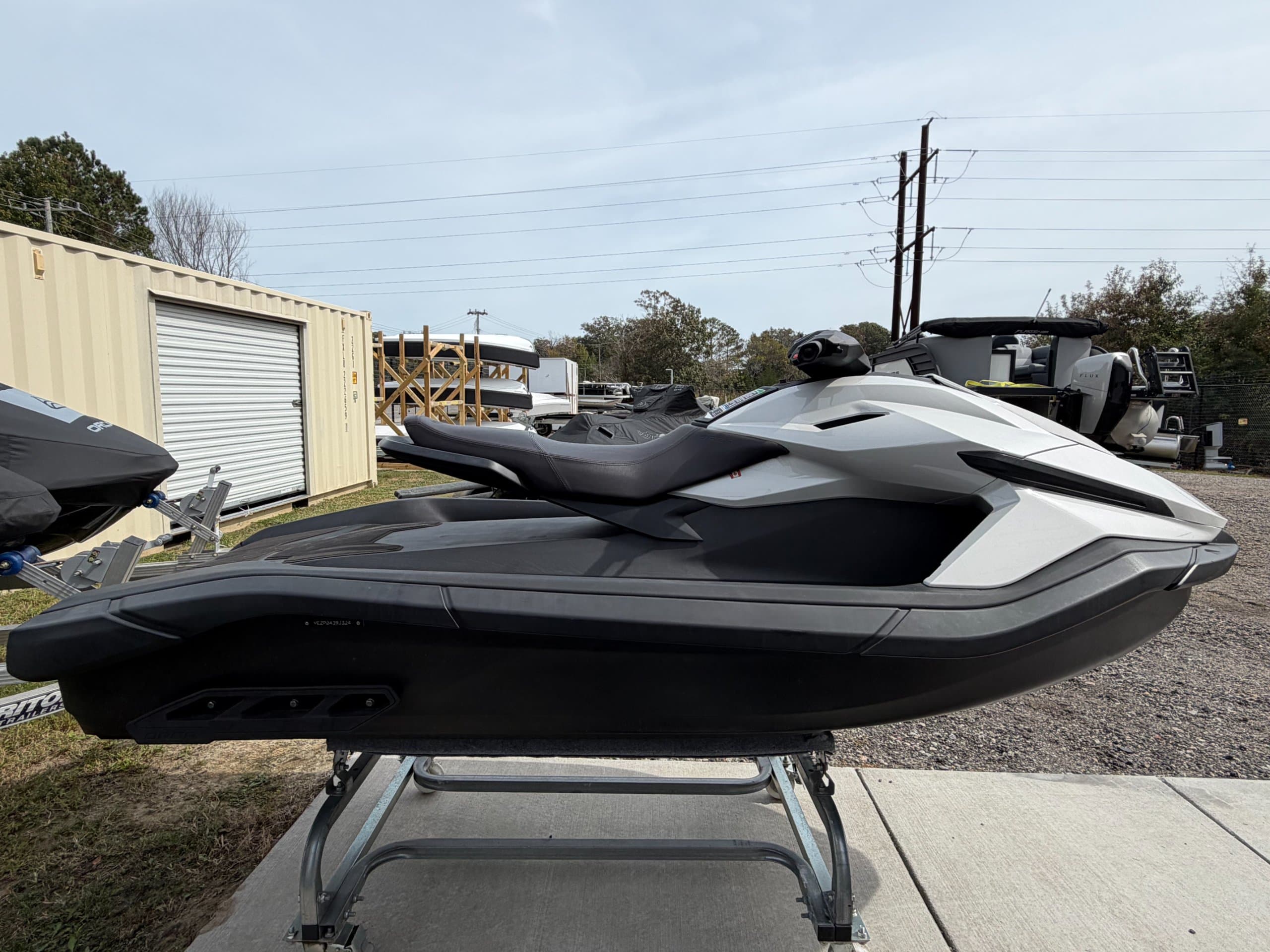 Side view of a white and black Taiga Orca P2 personal watercraft on a display stand.