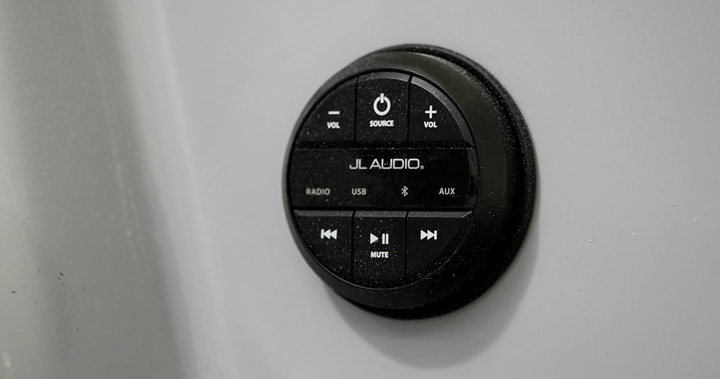 JL Audio marine stereo remote control mounted on a boat (2026 Vision Marine SPECTR) console.