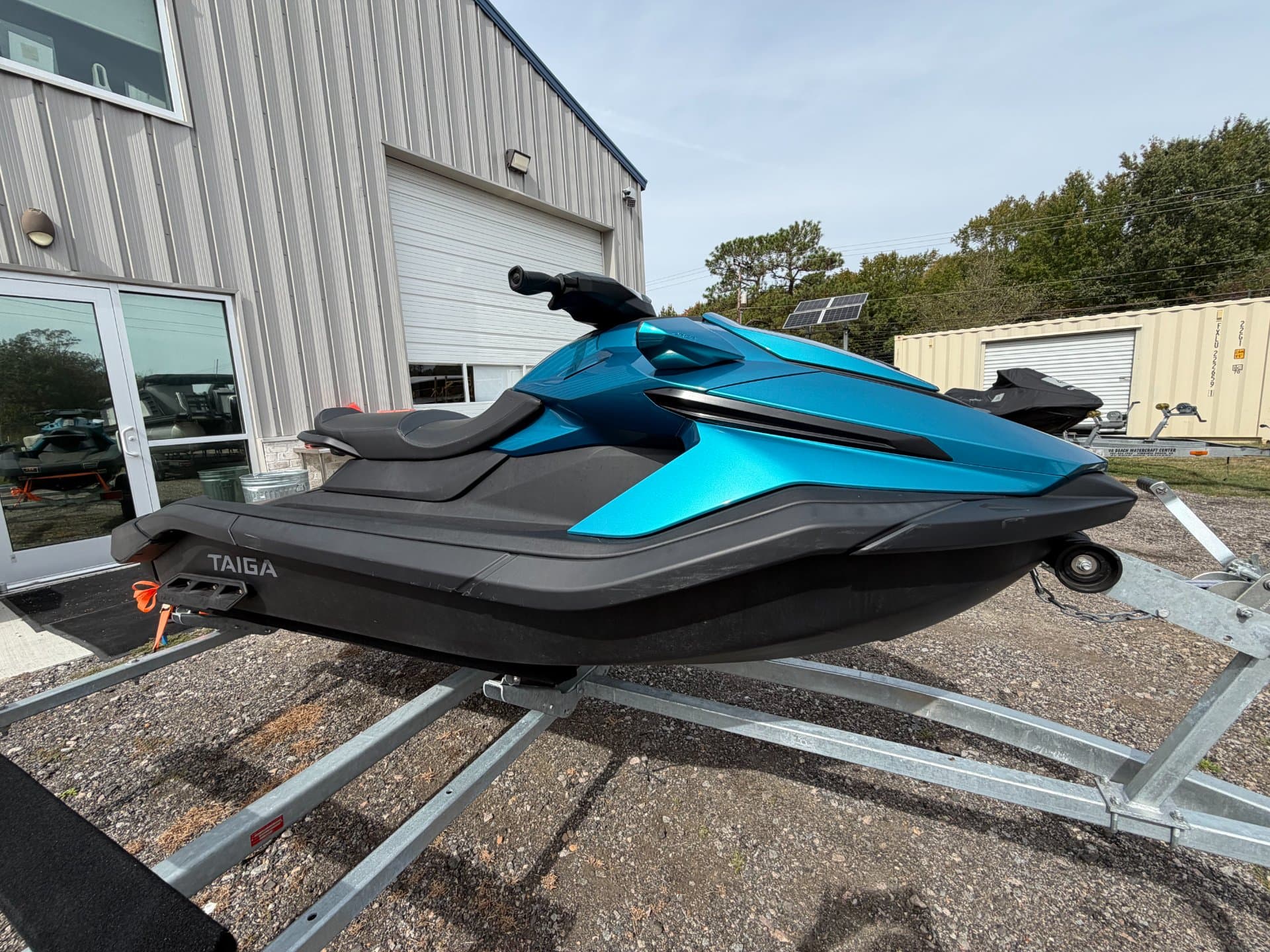 Side view of a blue and black Taiga Orca WX3 personal watercraft on a trailer.