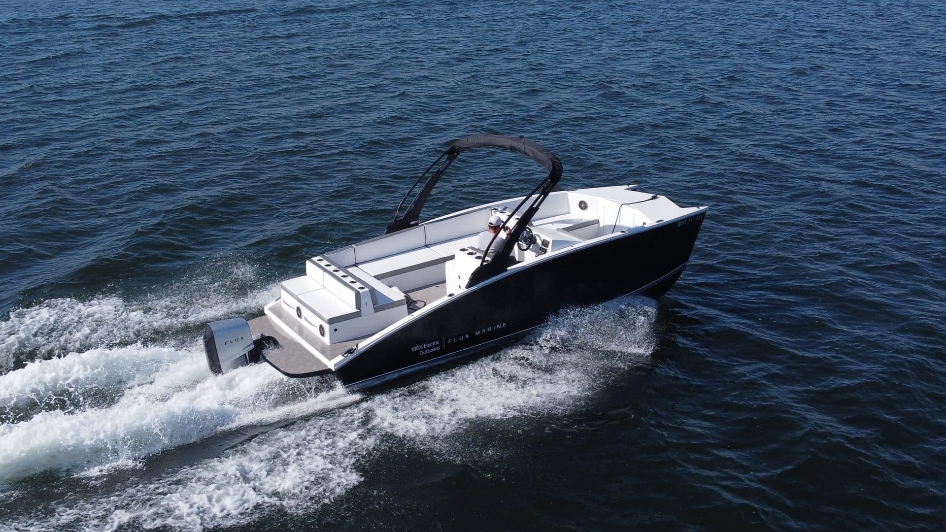 Flux Marine GFX Stealth powerboat viewed from above and behind, underway on open water with a visible wake