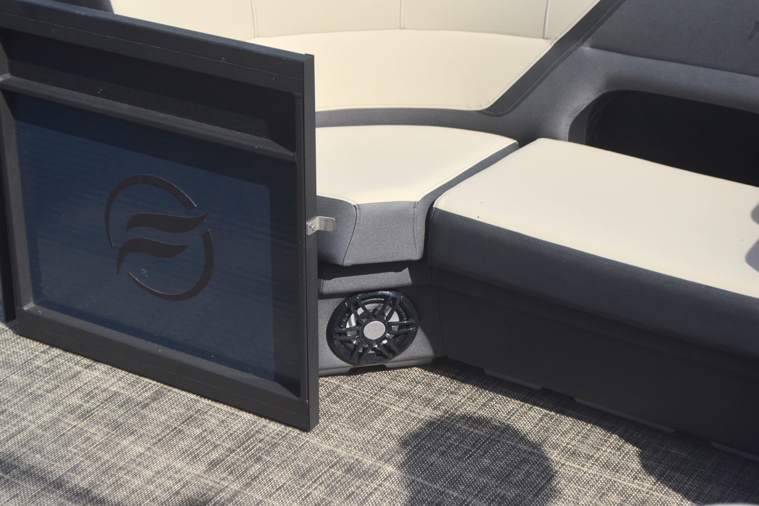 Flagship Discover interior close-up showing a speaker, cushioned seating, and a branded panel.