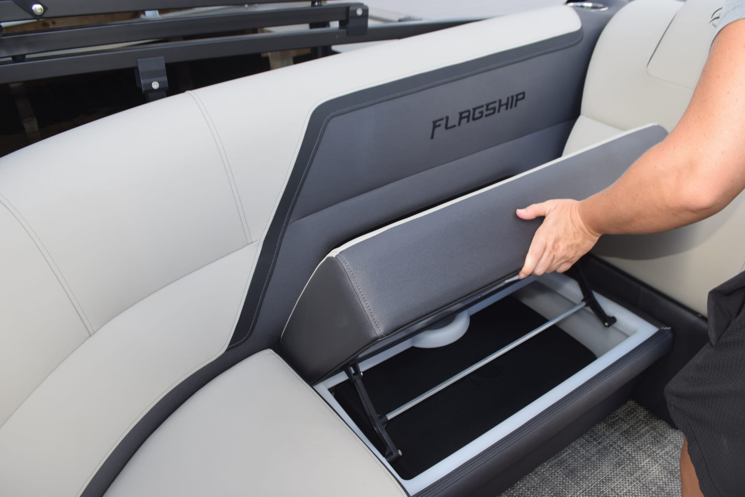 Flagship Discover seating area with an open under-seat storage compartment, viewed from above.