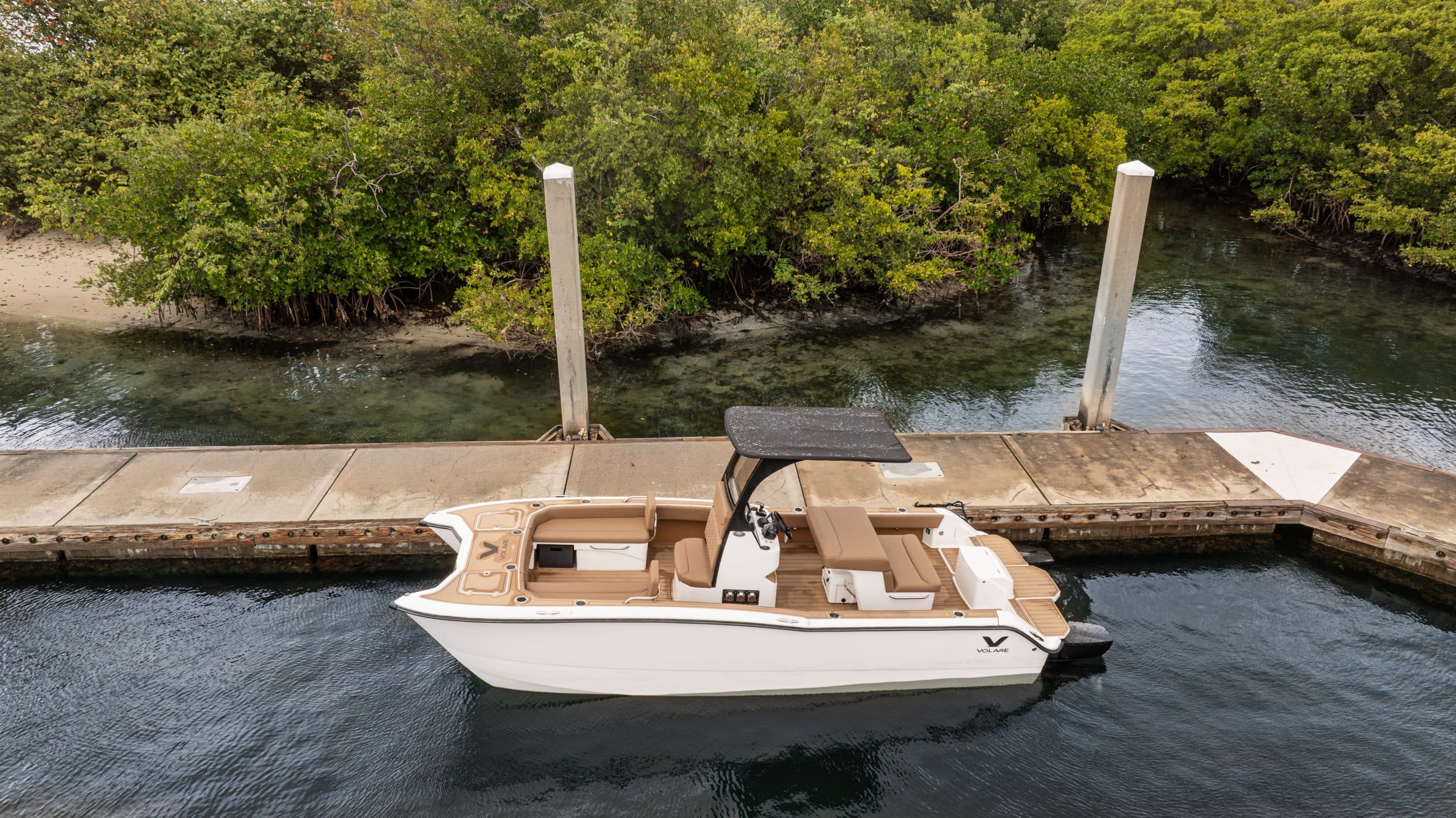 Volare Artemis 23 seen from above at a dock, showing the full boat, open cockpit, bow, and stern.