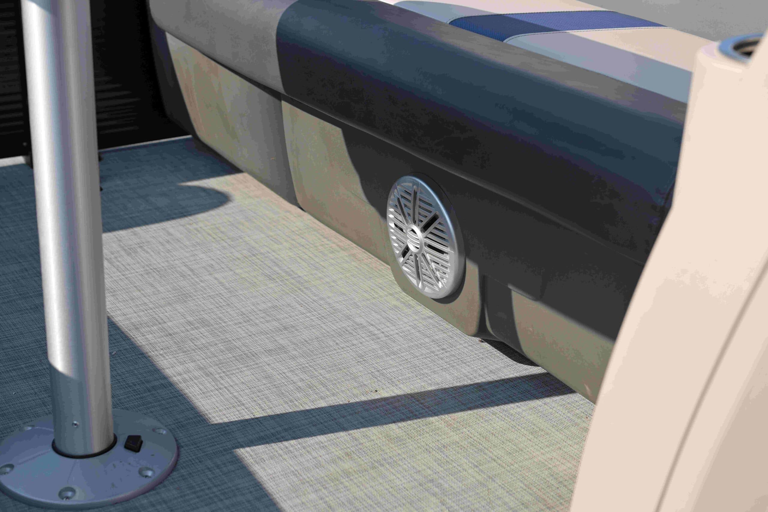 Close-up of a 2026 Princecraft Brio e 17’s carpeted deck, side bench base, and pedestal mount, viewed from above.