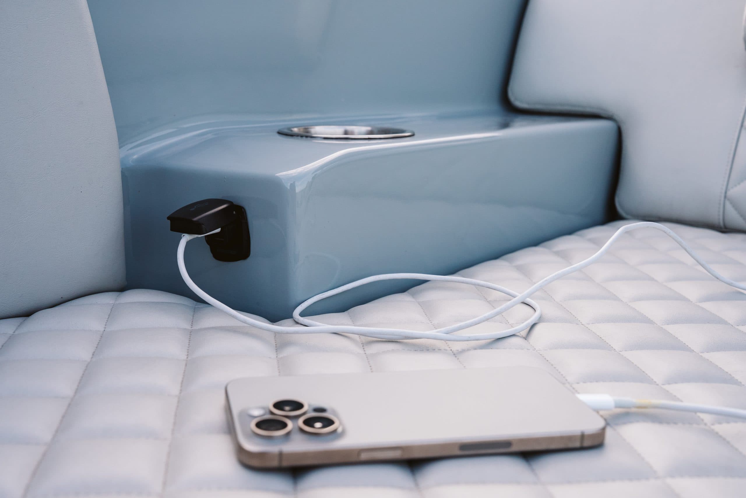 Halevai model2050 seating area with a smartphone and charging cable on the quilted cushion, viewed close up.