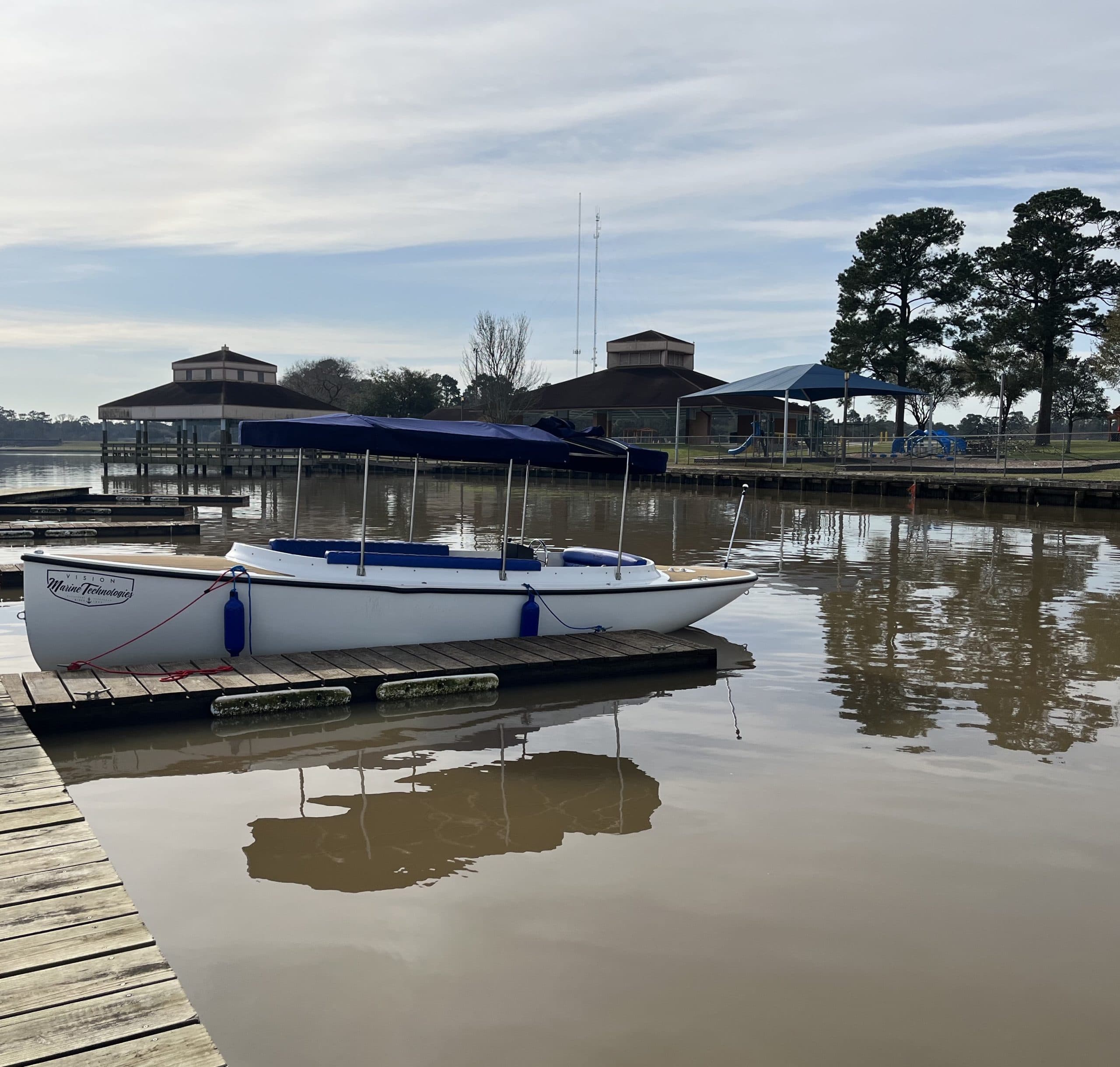 2022 Vision Marine Fantail moored at a marina, viewed from the dock at side profile.