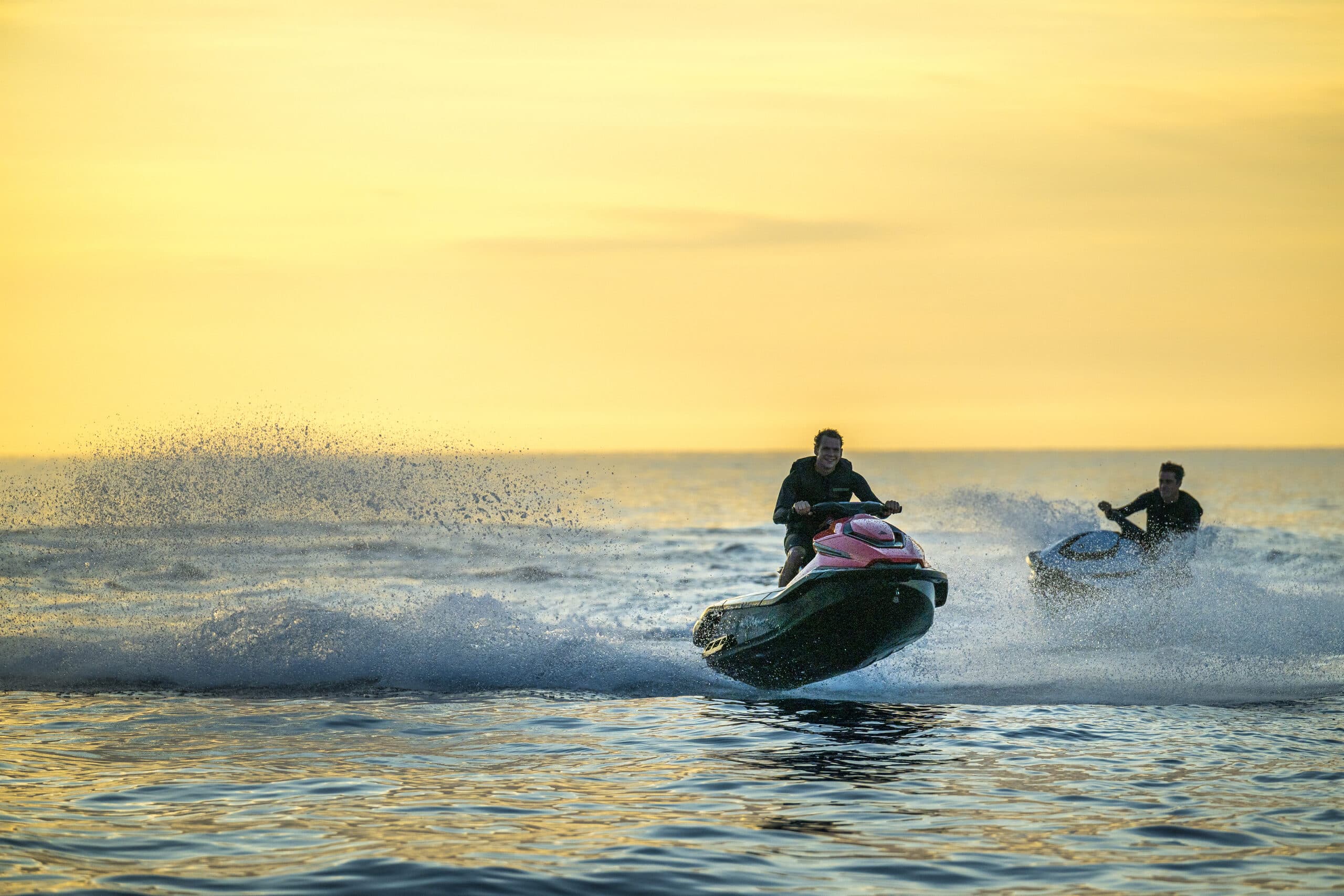 Taiga Orca P2 personal watercraft (Taiga Orca P2) turning across the water, viewed from the side, with another personal watercraft in the background