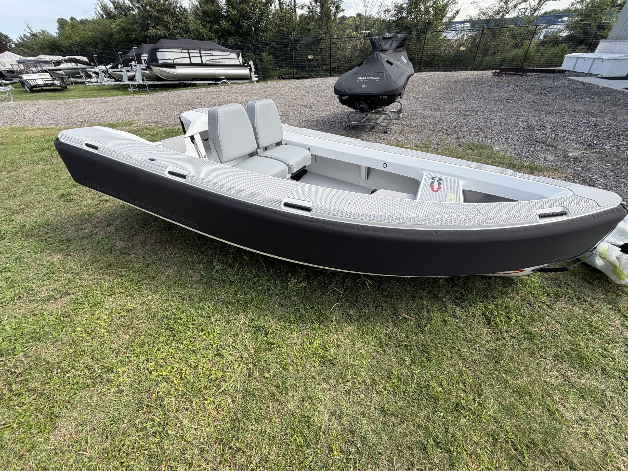 2026 Offshore Cruising Tenders OC300 Side view of a rigid inflatable tender with two forward-facing seats, open cockpit, and outboard motor at the stern.