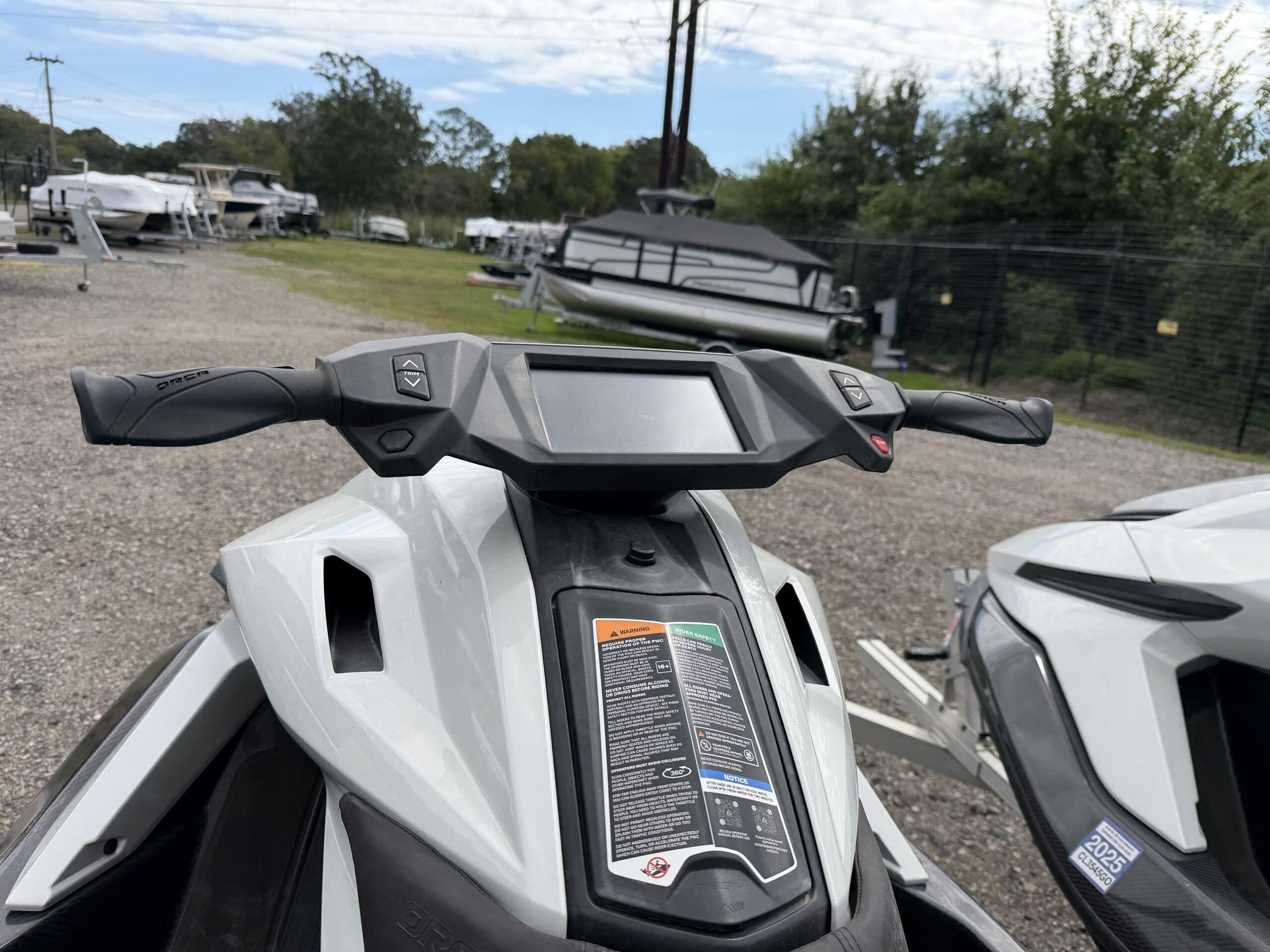 View from the rider’s position over the handlebars and dashboard of a Taiga Orca personal watercraft.