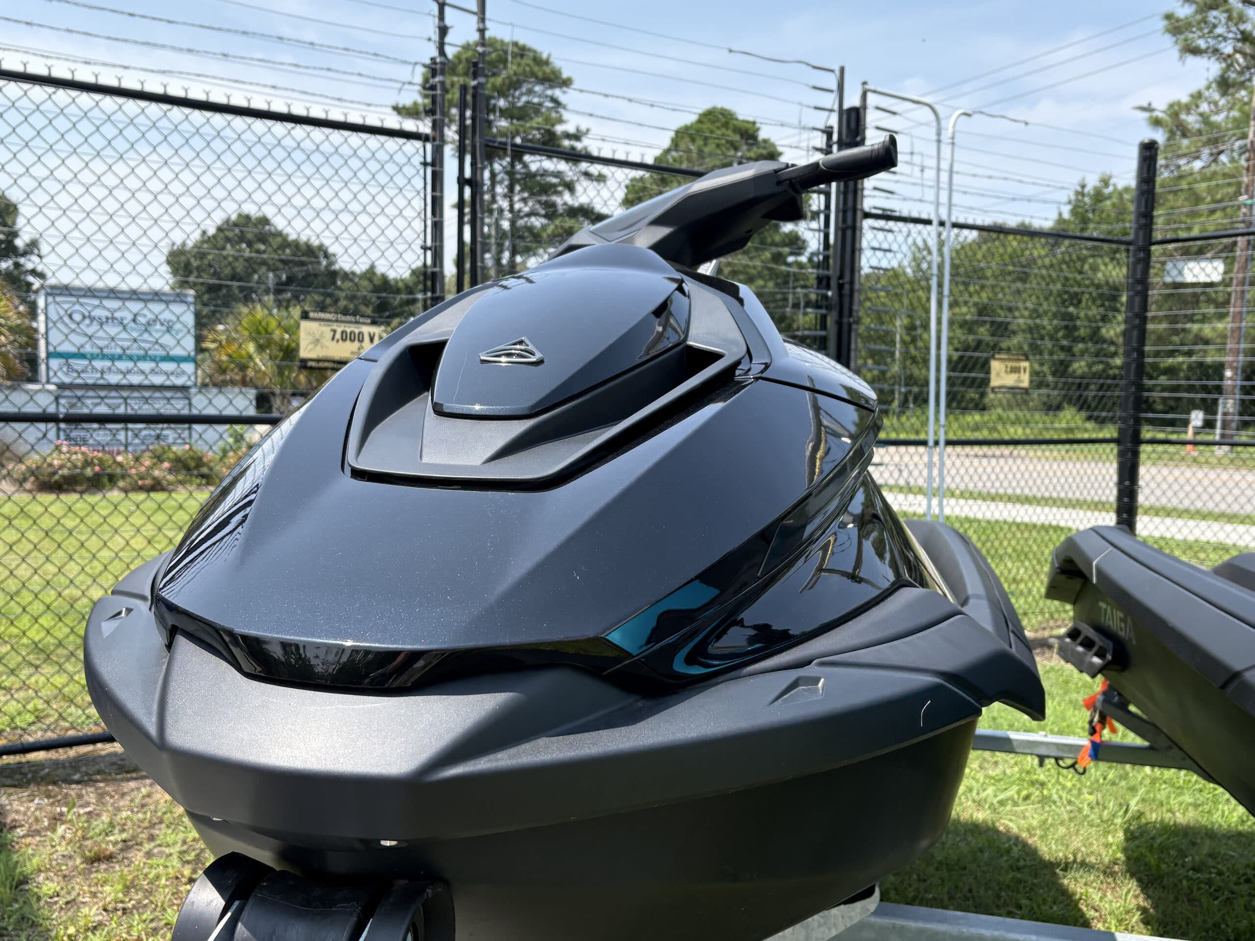 Front view of a black Taiga Orca P2 personal watercraft, showing the bow and handlebars.