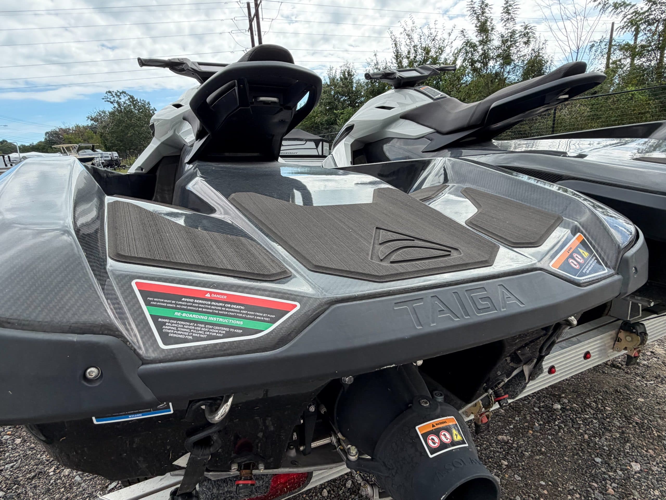 Rear deck and seats of a Taiga Orca Carbon personal watercraft, viewed from the stern at close range.