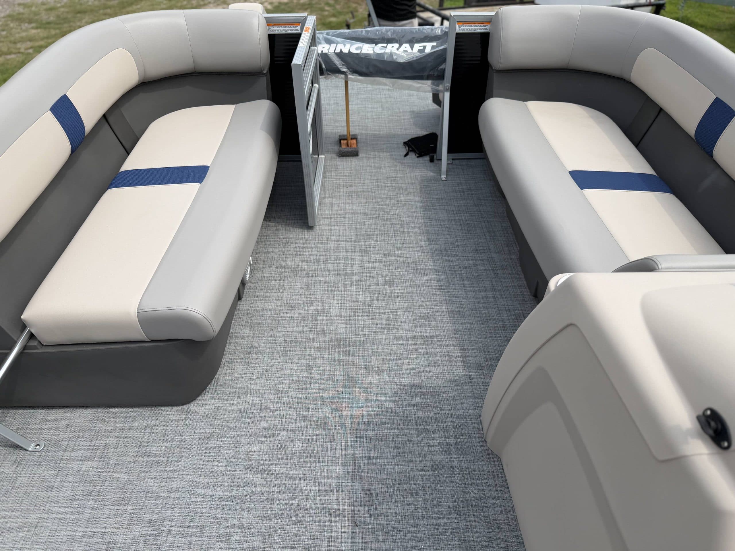 View from the bow into the cockpit of a Princecraft Jazz 19 4s, showing wraparound seating, carpeted floor, and helm console.