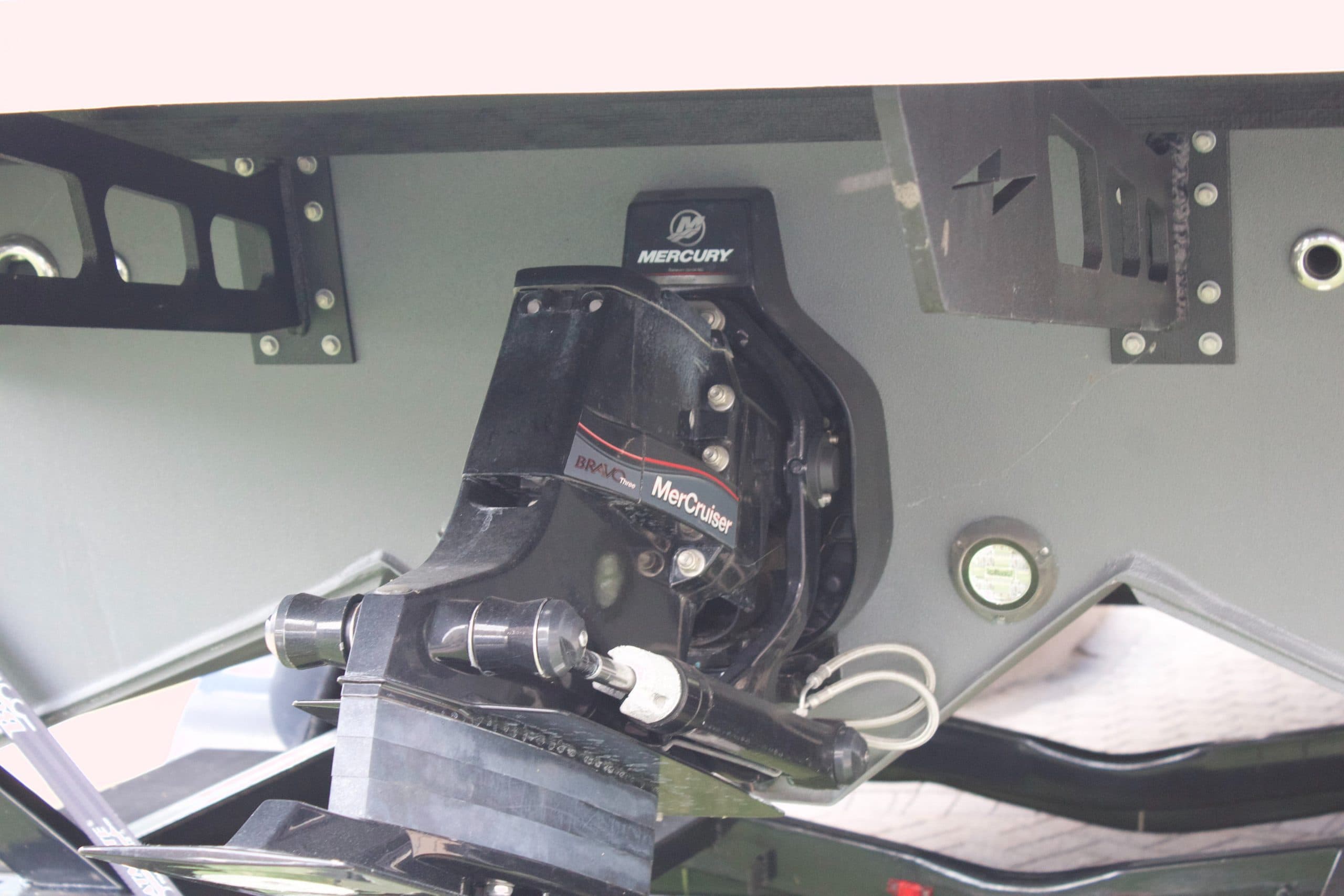 Close-up of a Mercury outboard motor mounted at the stern, viewed from behind the boat.