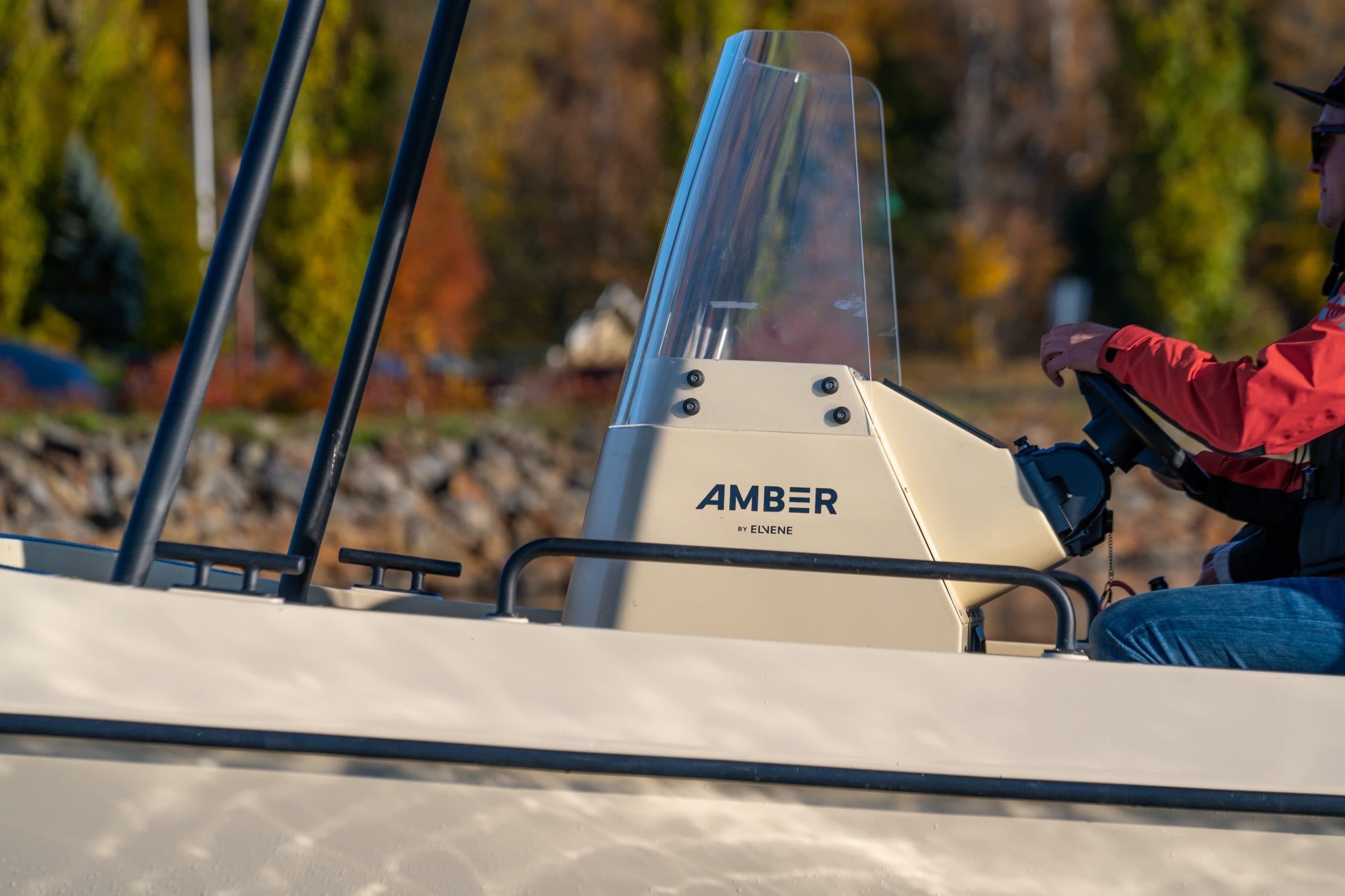 Elvene Amber helm console viewed from the side, with a person seated at the controls.