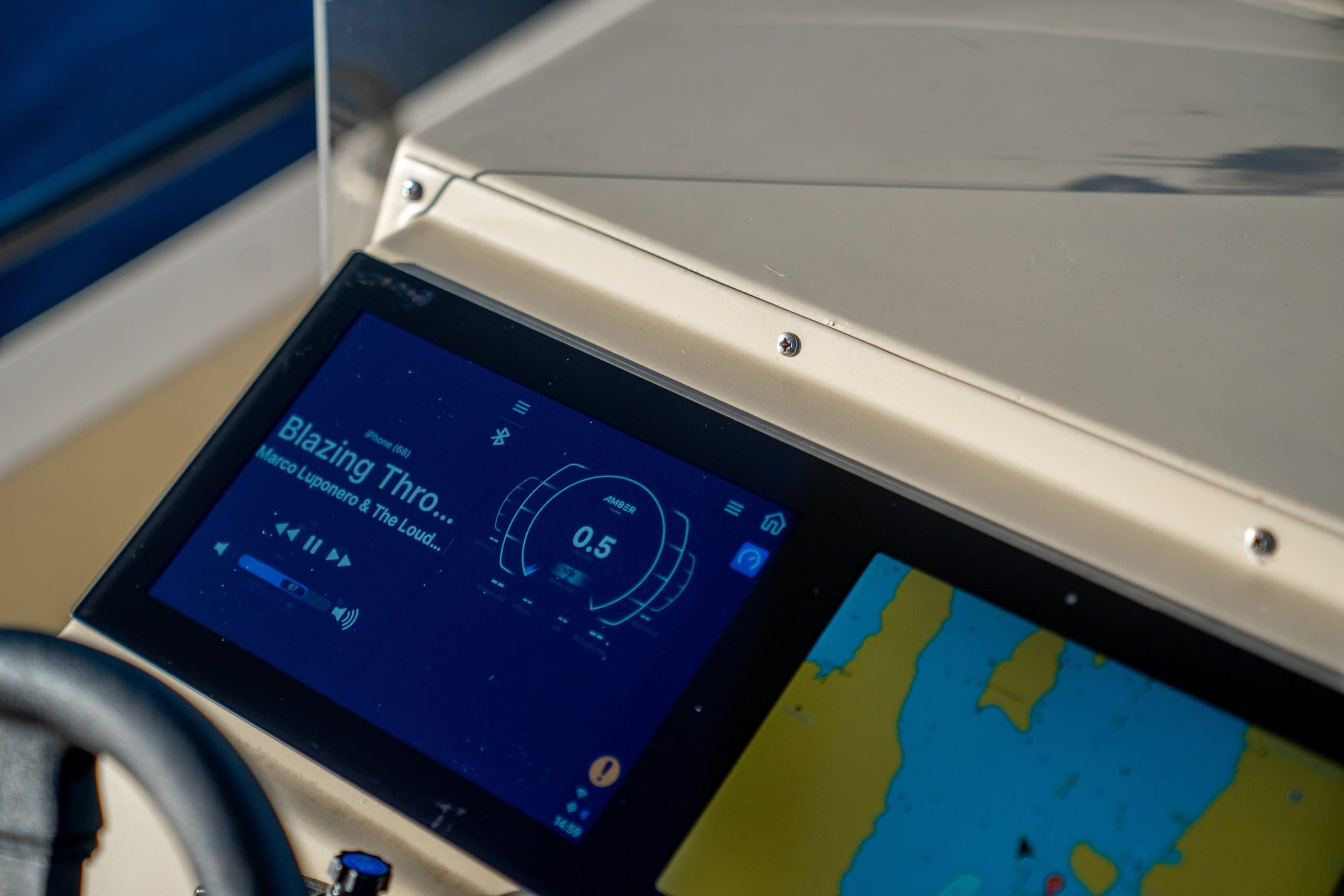 Elvene Amber helm display showing a digital navigation chart and instrument screen, viewed at an angle from the cockpit.