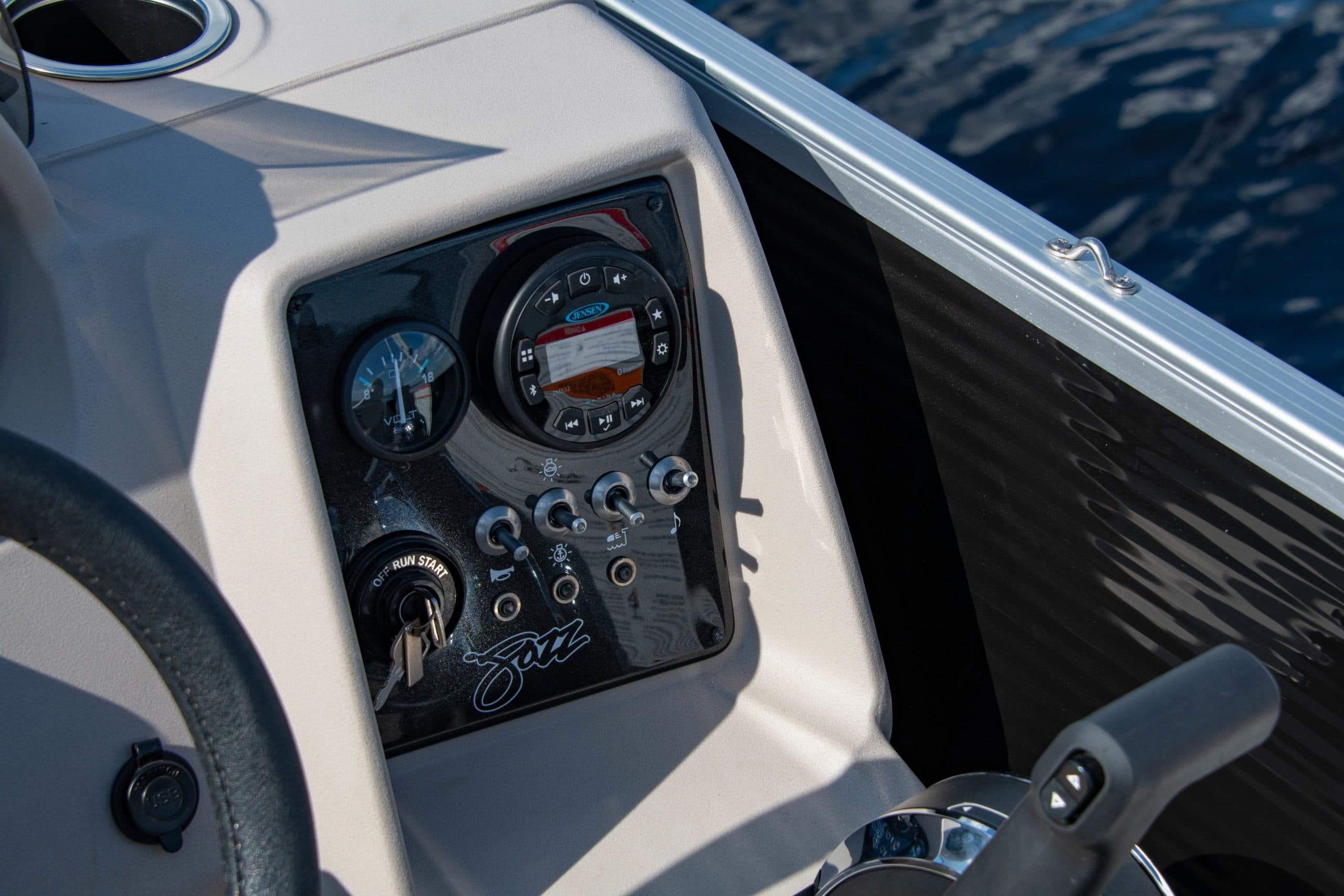 Close-up of the Princecraft Jazz 17 helm, showing the dashboard gauges, controls, ignition, and throttle.