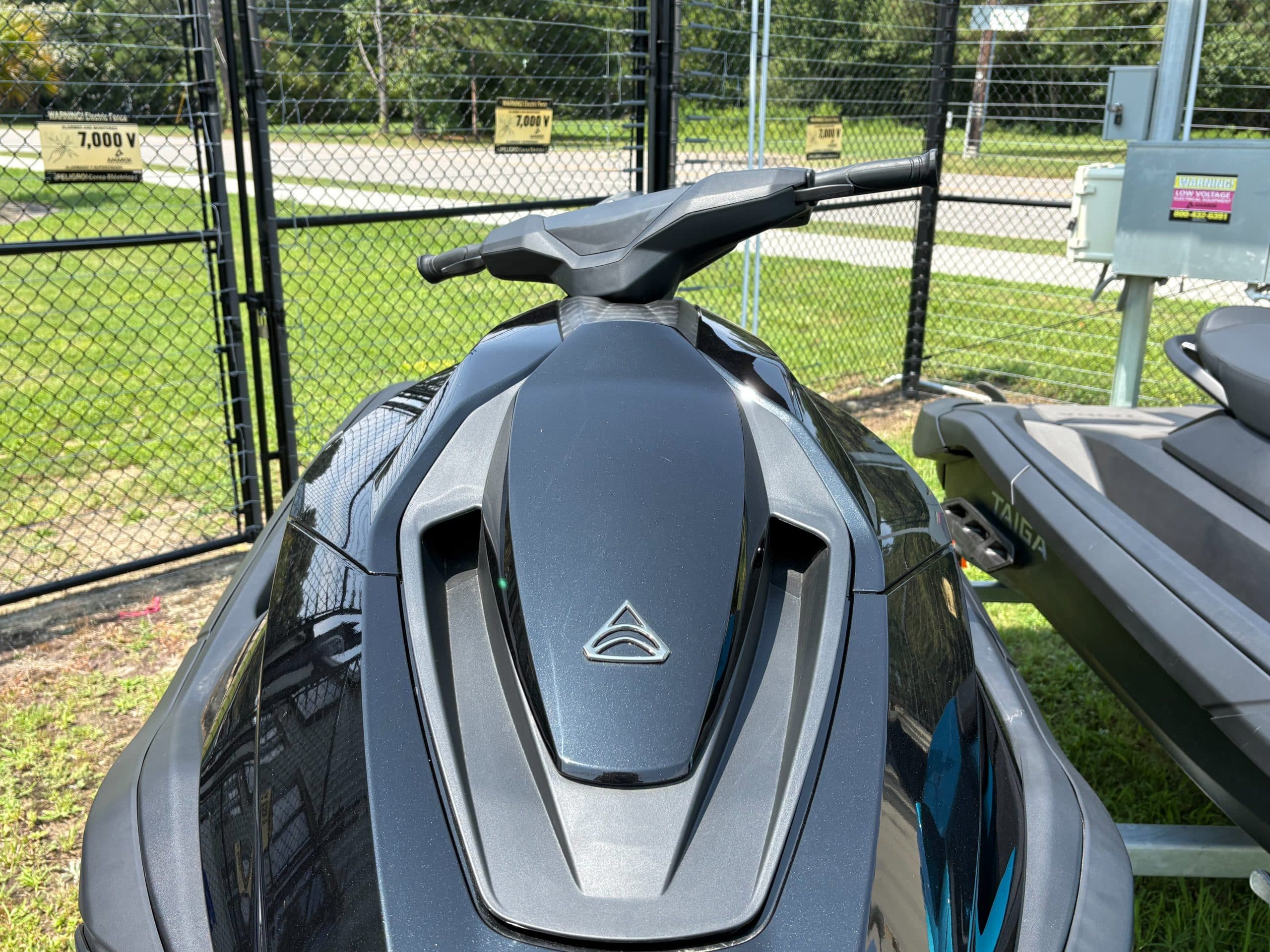 Front deck and handlebars of a black Taiga Orca P2 personal watercraft, viewed from above.