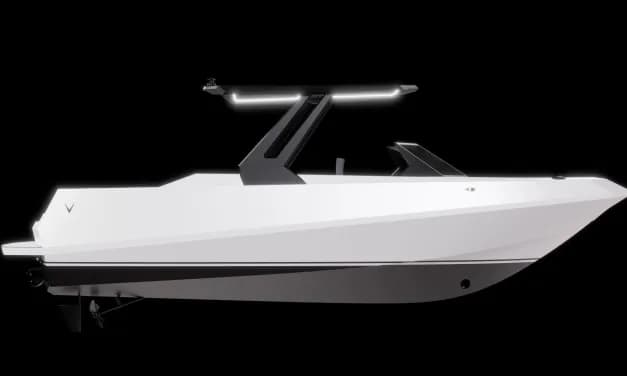 White enclosed electric boat with a sleek angular hull, raised windshield, and illuminated roof-mounted light bar, shown in side profile.