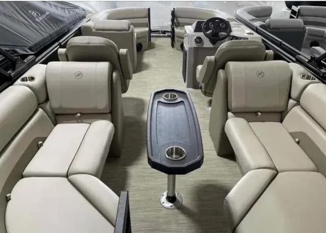Flagship Discover cockpit viewed from the bow, showing facing seating, a central pedestal table, and the helm at the rear.