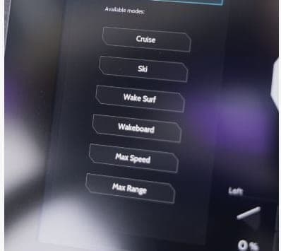 Close-up of a marine touchscreen displaying selectable modes: Cruise, Ski, Wake Surf, Wakeboard, Max Speed, and Max Range (2026 Voltaic AEW24).