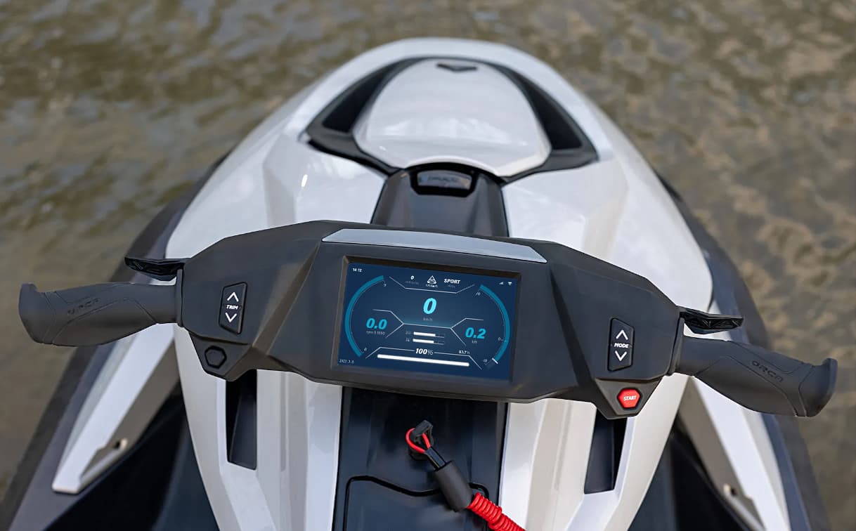Top-down view of a Taiga Orca P2 personal watercraft cockpit, handlebars, and digital dashboard on the water.