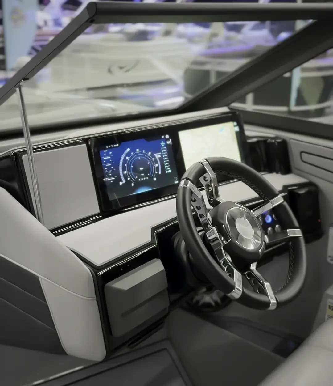 Helm console of a Vision Marine SPECTR, viewed from the cockpit, with steering wheel and two dashboard displays visible.