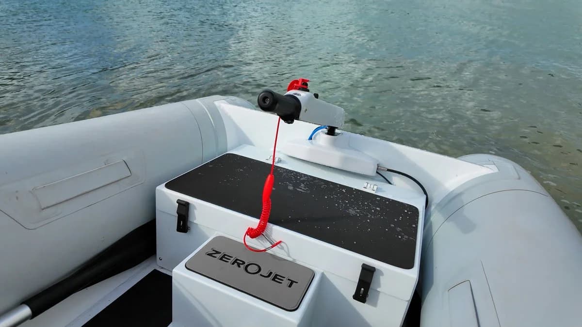 View from the stern into an inflatable boat’s cockpit, showing a ZeroJet-branded motor housing and black deck surface.