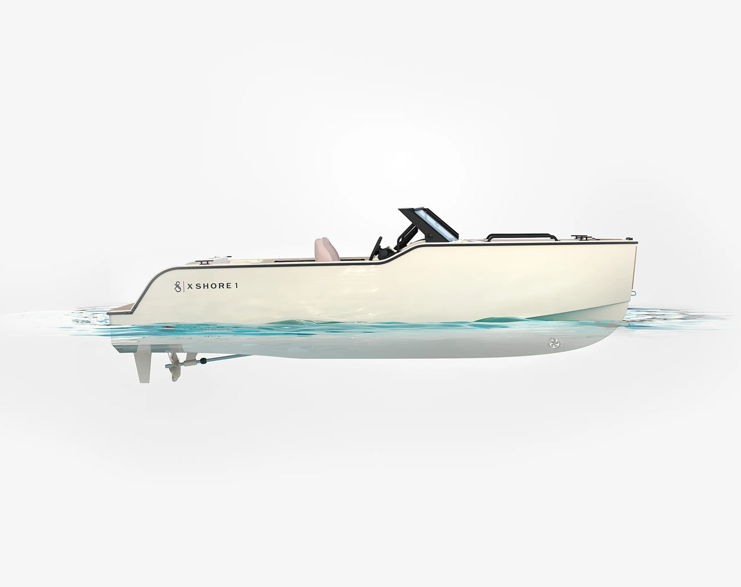 2024 Side profile of a cream-colored X Shore 1 electric boat shown cruising on calm water.